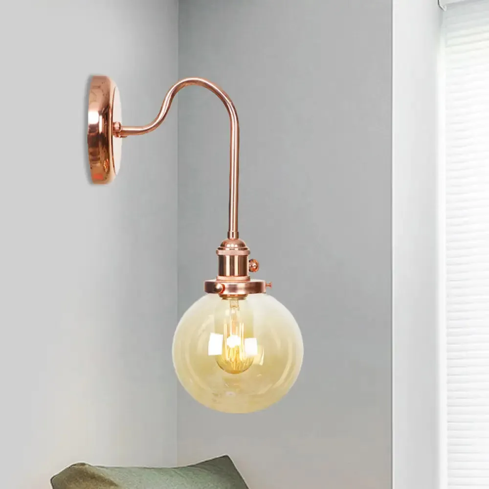 Copper Vintage Globe Wall Sconce with Curved Arm and Clear/Amber Glass - 1 Light