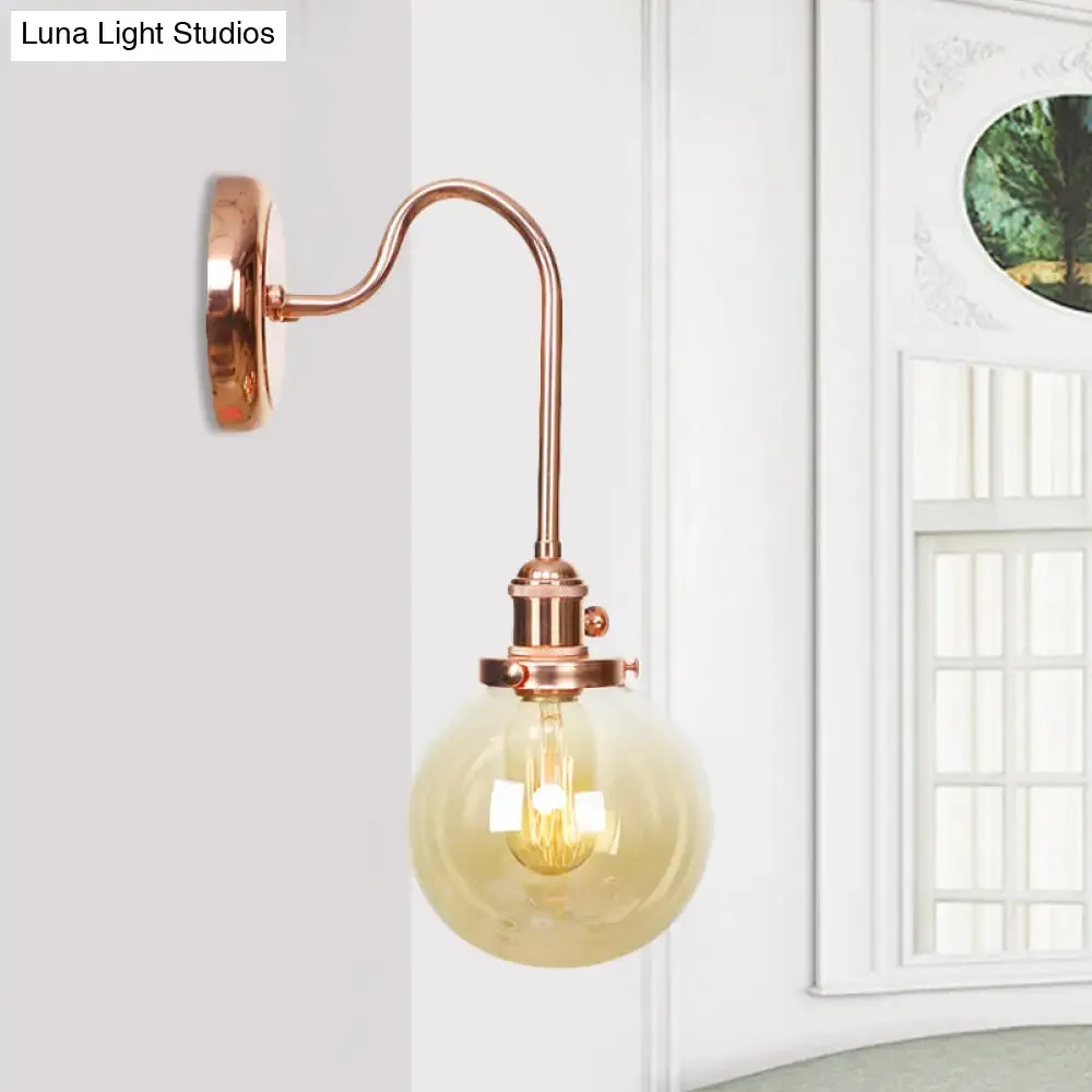 Copper Vintage Globe Wall Sconce with Curved Arm and Clear/Amber Glass - 1 Light