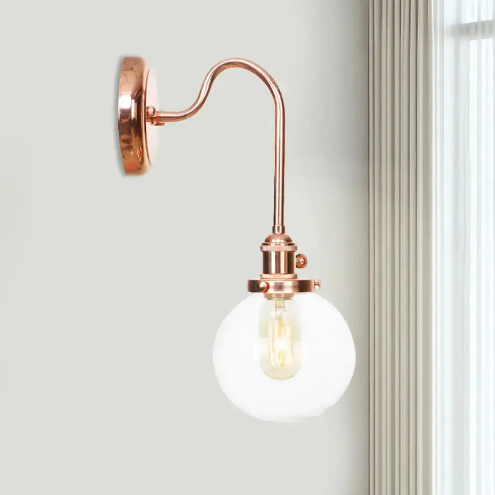 Copper Vintage Globe Wall Sconce with Curved Arm and Clear/Amber Glass - 1 Light