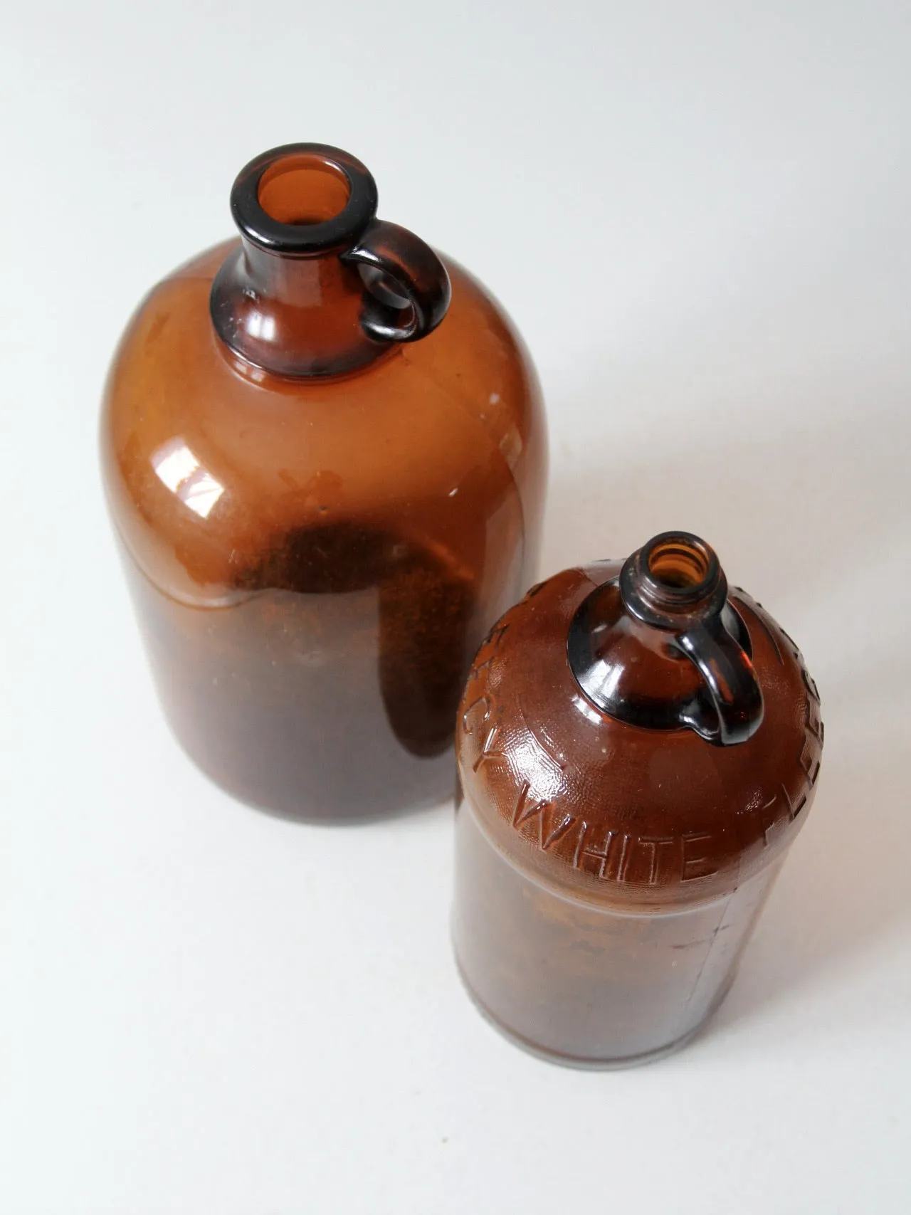 vintage brown glass bottle jugs pair